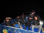 Five suspected drug smugglers in their vessel observed by Coast Guard law enforcement.