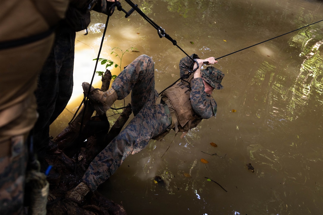 A U.S. Marine with 3rd Battalion, 2nd Marine Regiment, Littoral Combat Force-24, crosses a one-rope bridge as part of Jungle Operations Training Course - Panama in Colón, Panama, Aug. 10, 2026. JOTC-P tests participants’ ability to execute jungle warfare tactics, maintain security, and operate effectively in realistic, high stress scenarios. (U.S. Marine Corps photo)