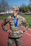 Maj. Annelise Rowe, assistant director of operations for the 224th Cyber Operations Squadron, Idaho Air National Guard, poses with her Boston Marathon medal at Gowen Field, Boise, Idaho. Rowe completed the 129th Boston Marathon, fulfilling a longtime goal inspired by watching her mother run the race in 1999. Photo by Master Sgt. Mercedee Wilds.