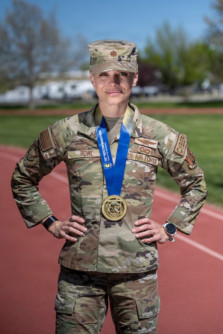 Maj. Annelise Rowe, assistant director of operations for the 224th Cyber Operations Squadron, Idaho Air National Guard, poses with her Boston Marathon medal at Gowen Field, Boise, Idaho.