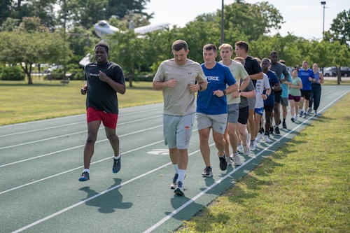 Image of group of people running on a track.