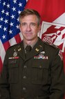 Official photo of Col. Brown with American and South Atlantic Division Flags in the background