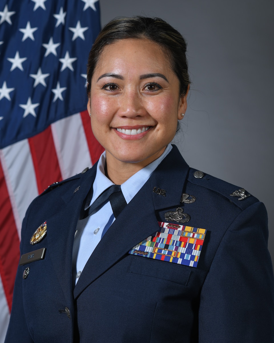 Woman in Air Force uniform in front of American Flag