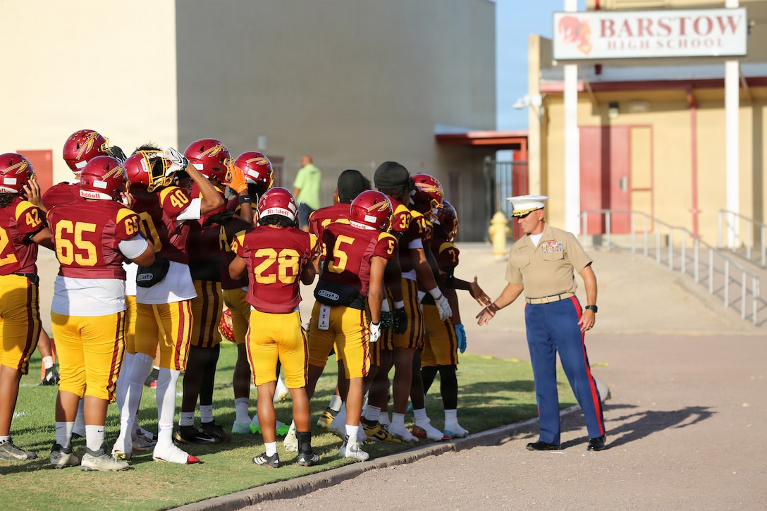 BARSTOW, Calif. — Colonel Russell W. Savatt IV, commanding officer, Marine Corps Logistics Base Barstow, stands alongside local community leaders as the MCLB Barstow Walking Color Guard presents the national and organizational colors during the opening ceremony of the Barstow High School Military Appreciation Night football game in Barstow, California, August 22. The annual community event brought together active-duty service members, veterans, military families, and residents to celebrate military heritage and strengthen the lifelong partnership between the installation and the city of Barstow. (U.S. Marine Corps photos by Katherine Cortez, COMMSTRAT)