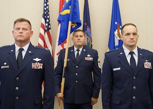 U.S. Air National Guard Col. Joseph Miller, 224th Air Defense Group commander, and Lt. Col. Jacob Searles stand at attention during the 224th Support Squadron assumption of command ceremony held at the Eastern Air Defense Sector on August 21, 2026. Miller presided over the ceremony, welcoming Searles as the squadron’s new commander. (U.S. Air National Guard photo by Barbara Olney)
