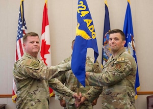 Maj. Devin J. Will, right, accepts the 224th Security Forces Squadron guidon from Col. Joseph J. Miller Jr., 224th Air Defense Group commander, during an assumption of command ceremony on July 27 at the Eastern Air Defense Sector in Rome, New York. The guidon exchange serves as the ceremony’s centerpiece and symbolizes the passing of command to a new commander. (Air National Guard photo by Barbara Olney)