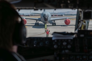 An Airman assigned to the 92nd Aircraft Maintenance Squadron, martials a KC-135 Stratotanker after a flight at Fairchild Air Force Base, Washington, July 29, 2026