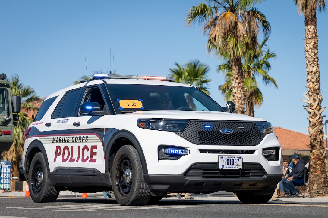 A U.S. Marine Corps squad car assigned to the Provost Marshal’s Office, Marine Air-Ground Task Force Training Command, Marine Corps Air-Ground Combat Center, participates in the 88th Annual Pioneer Days Parade at Twentynine Palms, California, Oct. 19, 2024. The Combat Center participated in the community event to provide Marines and Sailors a meaningful opportunity to forge connections with the local community, showcasing their commitment to service and camaraderie. (U.S. Marine Corps photo by Lance Cpl. Iris Gantt)