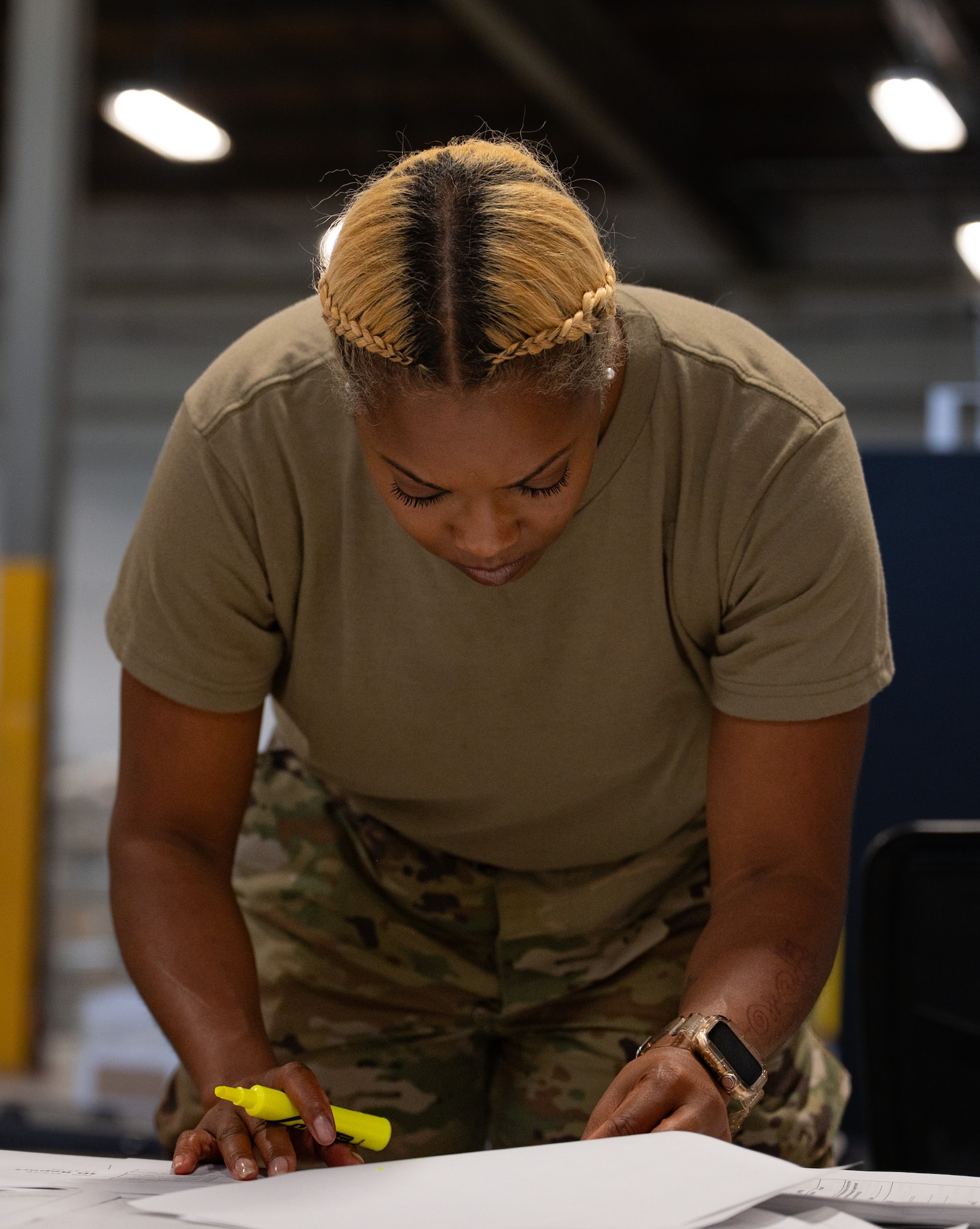 U.S. Air Force Tech. Sgt. Yvette Starling, 514th Logistics Readiness Squadron supply technician, checks paperwork during a personnel deployment function line at Joint Base McGuire-Dix-Lakehurst, N.J., Aug. 24, 2026. Personnel deployment function lines are used to ensure personnel preparing for deployment are equipped with proper documentation and equipment. (U.S. Air Force photo by Airman 1st Class Haeleigh Bayle)