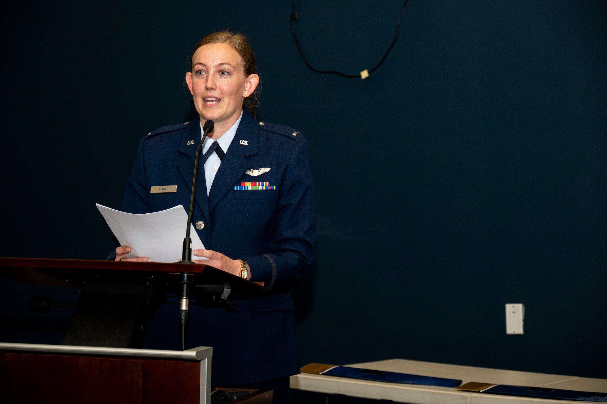 Woman speaks at podium.