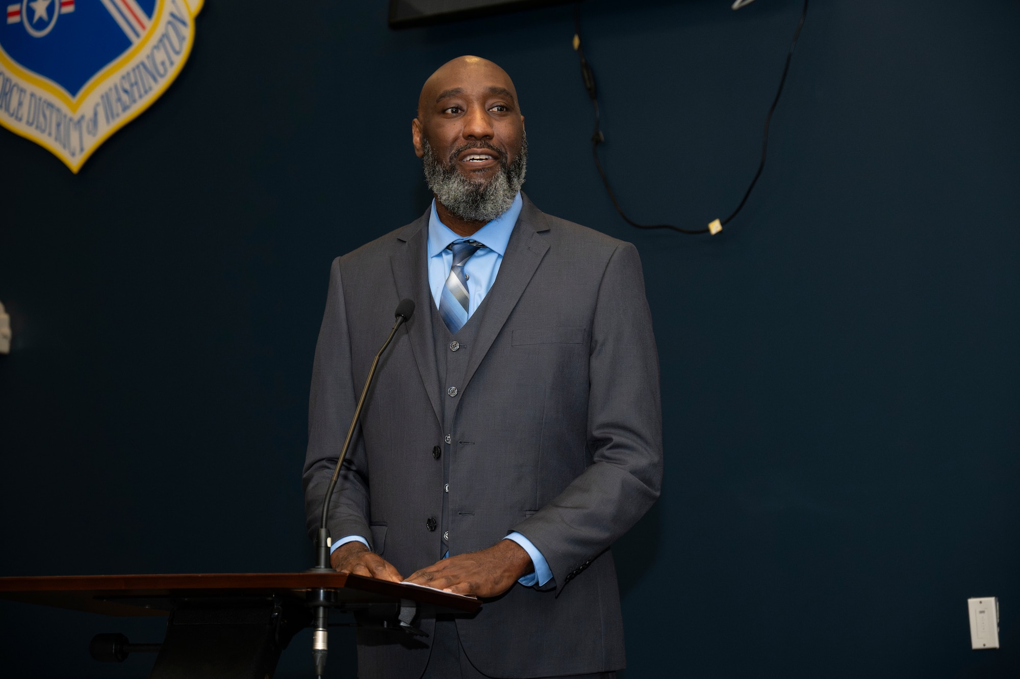 Man speaks at podium.
