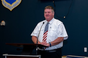 Man speaks at podium.