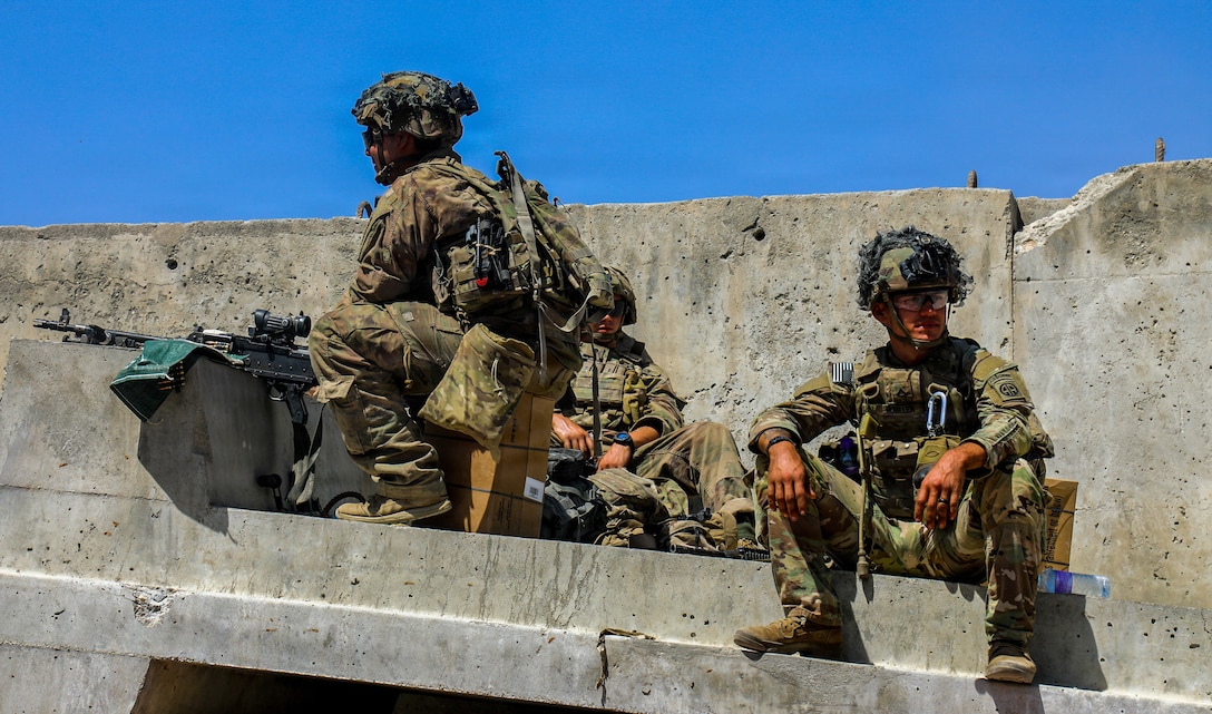 Paratroopers assigned to the 1st Brigade Combat Team, 82nd Airborne Division conducts checks as evacuees come through the gate. The Division continues to help facilitate the safe evacuation of U.S. citizens, Special Immigrant Visa applicants, and other at-risk Afghans out of Afghanistan as quickly and safely as possible from Hamid Karzai International Airport in Kabul.(U.S. Army photo by Sgt. Jillian Hix)