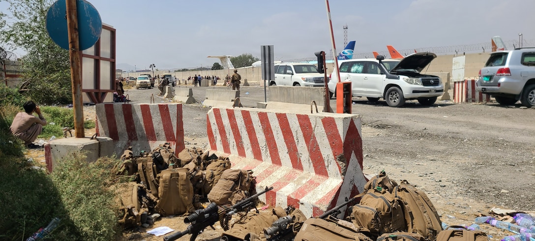 Gear belonging to U.S. Marines with Golf Company, 2nd Platoon, 1st Marine Division, rests behind a barricade at Hamid Karzai International Airport during Non-combatant Evacuation Operations in Kabul, Afghanistan, 2021. The photograph was captured prior to the attack at Abbey Gate while forces-maintained perimeter security at the airfield. (Courtesy photo by Lance Cpl. Noah Smith)