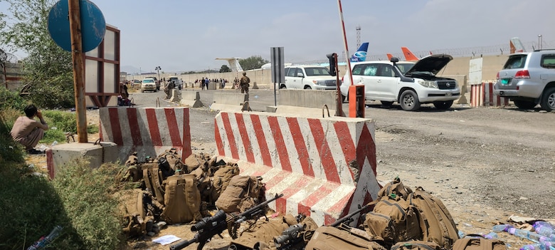 Gear belonging to U.S. Marines with Golf Company, 2nd Platoon, 1st Marine Division, rests behind a barricade at Hamid Karzai International Airport during Non-combatant Evacuation Operations in Kabul, Afghanistan, 2021. The photograph was captured prior to the attack at Abbey Gate while forces-maintained perimeter security at the airfield. (Courtesy photo by Lance Cpl. Noah Smith)