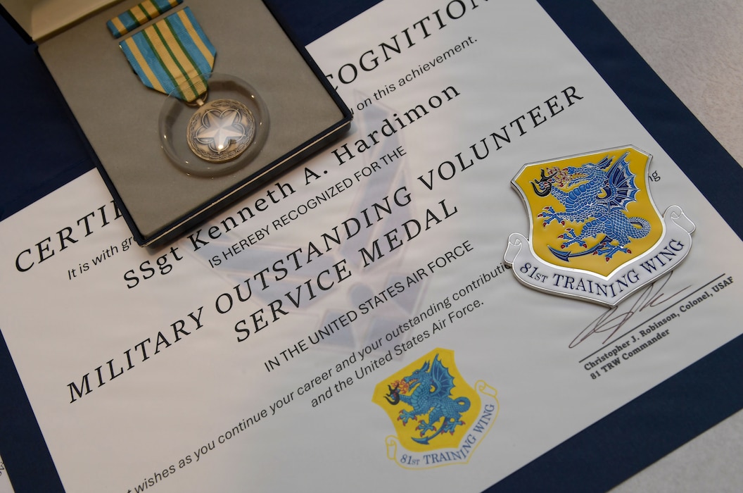 A military certificate and medal are on display.