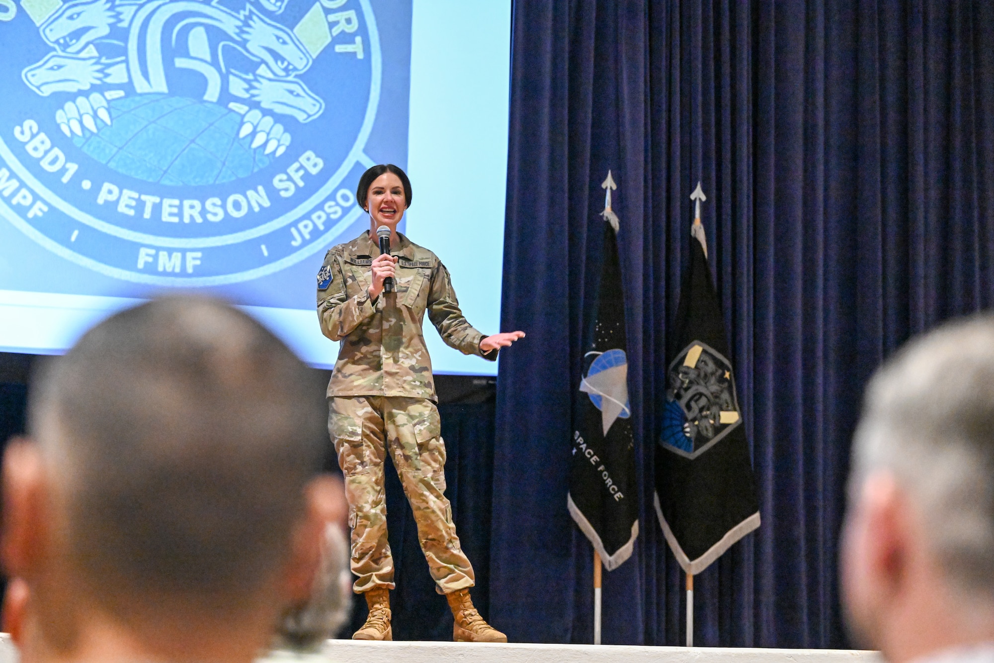 Chief Master Sgt. Willams stands on the stage addressing the audience
