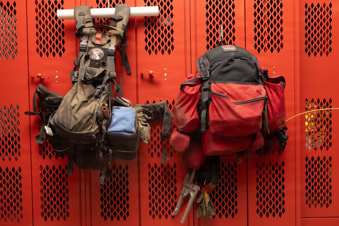 Gear hangs on lockers at Camp Pendleton Fire Station 4 at Marine Corps Base Camp Pendleton, Calif., Aug. 19, 2026. The Camp Pendleton Fire Department has operated since 1942 and comprises over 100 firefighters across 11 stations; it provides wildland fire suppression, advanced life support, emergency medical services, technical rescue, hazmat services and fire prevention and inspection. (U.S. Marine Corps photo by Cpl. Jacqueline Akamelu)
