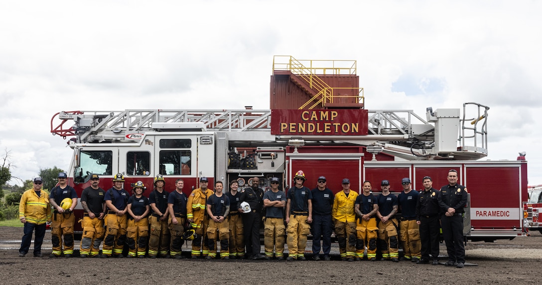 Firefighters with the Camp Pendleton Fire Department pose for a photo during Fire Demonstration Day at the CPFD Training Center at Marine Corps Base Camp Pendleton, Calif., April 17, 2025. The CPFD responds to search and rescue, hazmat, EMS, and live fire emergencies on and off base. (U.S. Marine Corps photo by Cpl. Jacqueline Akamelu)