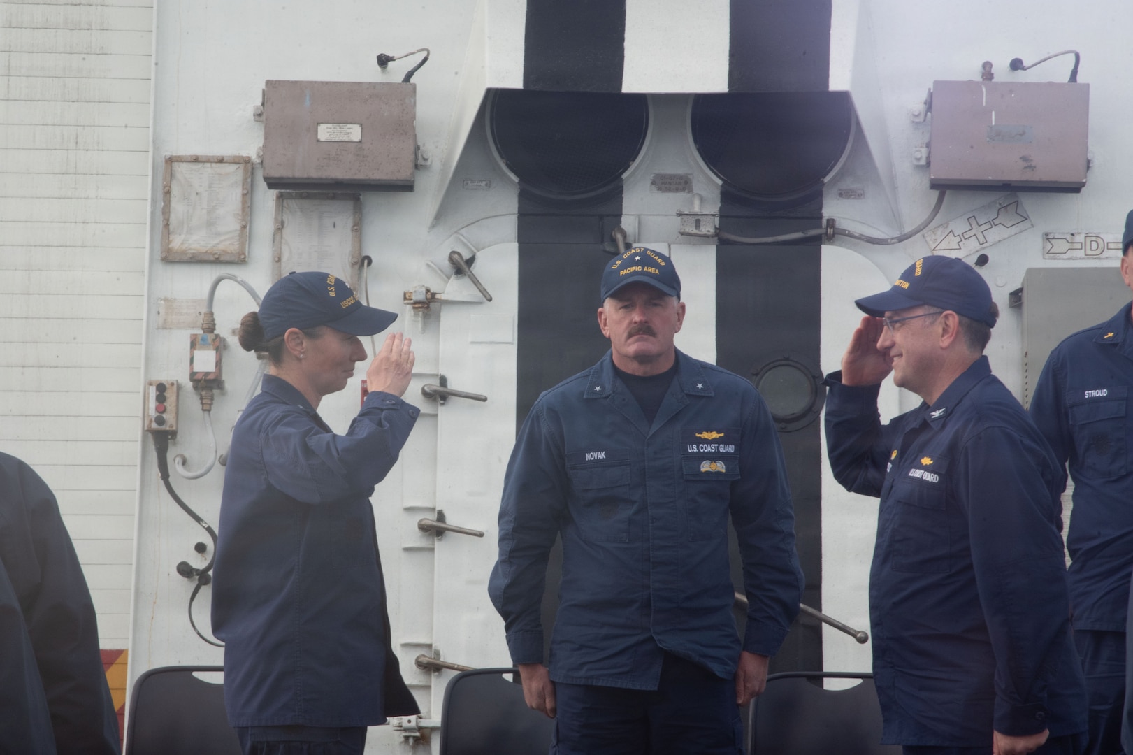 U.S. Coast Guard Rear Adm. Jeffery Novak, center, deputy commander of Coast Guard Pacific Area, presides over a change of command ceremony for Capt. Matthew Press, right, and Rear Adm. Dorothy Hernaez, left, aboard U.S. Coast Guard cutter Stratton (WMSL 752) while anchored off the coast of Kotzebue, Alaska, Aug. 24, 2026.