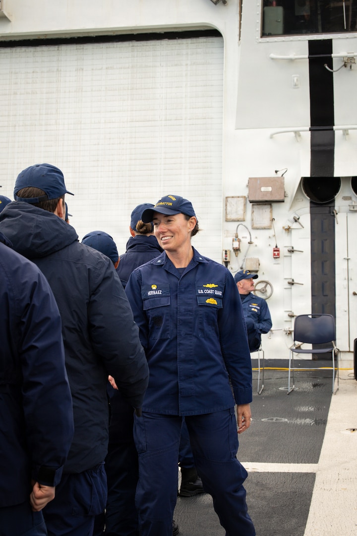 U.S. Coast Guard Rear Adm. Dorothy Hernaez walks through the ranks and shakes hands with crew members of the U.S. Coast Guard Legend-class national security cutter Stratton (WMSL 752) following a change of command ceremony while anchored off the coast of Kotzebue, Alaska, Aug. 24, 2026.