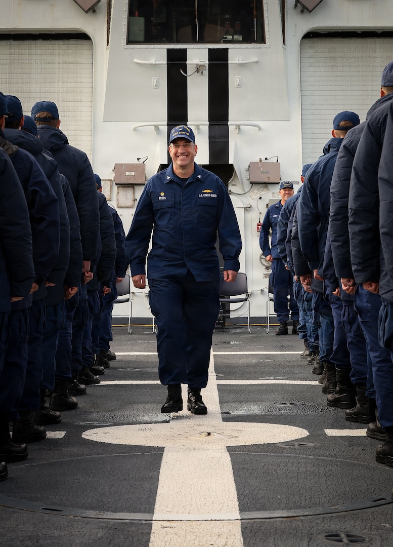 U.S. Coast Guard Capt. Matthew Press walks through the ranks of the U.S. Coast Guard Legend-class national security cutter Stratton (WMSL 752) crew after officially assuming command during a change of command ceremony while anchored off the coast of Kotzebue, Alaska, Aug. 24, 2026.