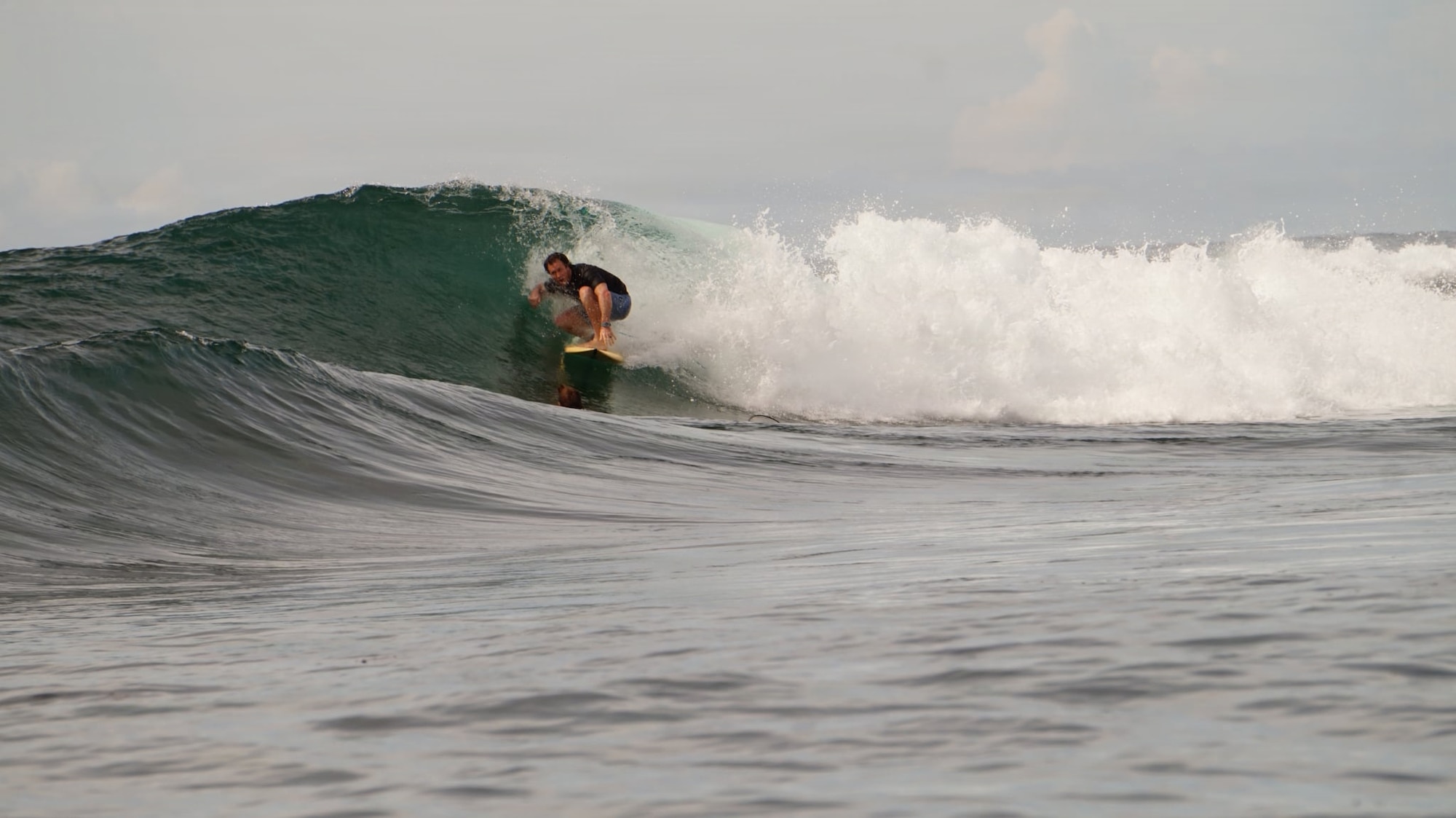Nick Pallett, American Red Cross Lifesaving Award recipient, surfs at a beach in northern Japan.