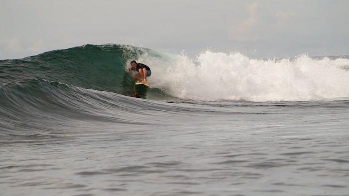 Nick Pallett, American Red Cross Lifesaving Award recipient, surfs at a beach in northern Japan.