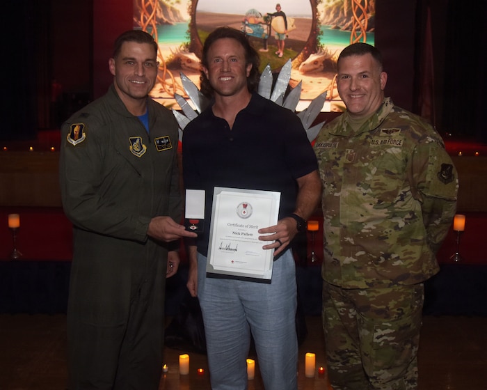 Nick Pallet, center, receives the American Red Cross Lifesaving Award from U.S. Air Force Col. Oliver Lause, 35th Fighter Wing (FW) commander, left, and Chief Master Sgt. Jason Amaxopulos, 35 FW command chief, right, during a Wing Quarterly Awards ceremony.