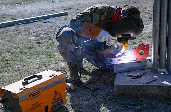 Steelworker 2nd Class Autumn Bridges, assigned to Amphibious Construction Battalion (ACB) 1, welds a structural steel frame as part of a Pacific Partnership 2026 (PP26) engineering project at the Escola Básica Filial Kasnafar schoolhouse in Dili, Timor-Leste, Aug. 20, 2026.