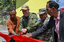 Canadian Armed Forces Col. Alain Lafrenière, center left, deputy mission commander of Pacific Partnership 2026 (PP26), cuts a ceremonial ribbon with Timor-Leste Defence Force (F-FDTL) Lt. Col. Laurentino Gusmao Adolzino, center right, a representative from the Timor-Leste Ministry of Defense, Mr. Adolzino Jose Soares, left, a representative from the Timor-Leste Ministry of Education, and Mr. Atanasio Marques, right, Escola Básica Filial (EBF) Kasnafar school principal, during a ribbon-cutting ceremony for a PP26 engineering line of effort construction project at EBF Kasnafar in Dili, Timor-Leste, Aug. 24, 2026.