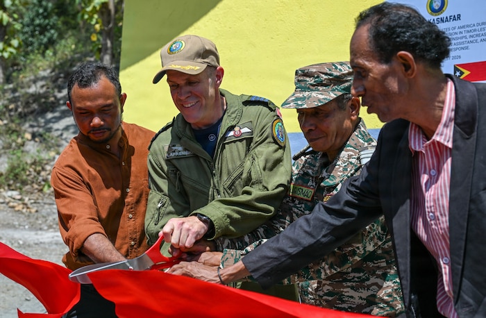 Canadian Armed Forces Col. Alain Lafrenière, center left, deputy mission commander of Pacific Partnership 2026 (PP26), cuts a ceremonial ribbon with Timor-Leste Defence Force (F-FDTL) Lt. Col. Laurentino Gusmao Adolzino, center right, a representative from the Timor-Leste Ministry of Defense, Mr. Adolzino Jose Soares, left, a representative from the Timor-Leste Ministry of Education, and Mr. Atanasio Marques, right, Escola Básica Filial (EBF) Kasnafar school principal, during a ribbon-cutting ceremony for a PP26 engineering line of effort construction project at EBF Kasnafar in Dili, Timor-Leste, Aug. 24, 2026.