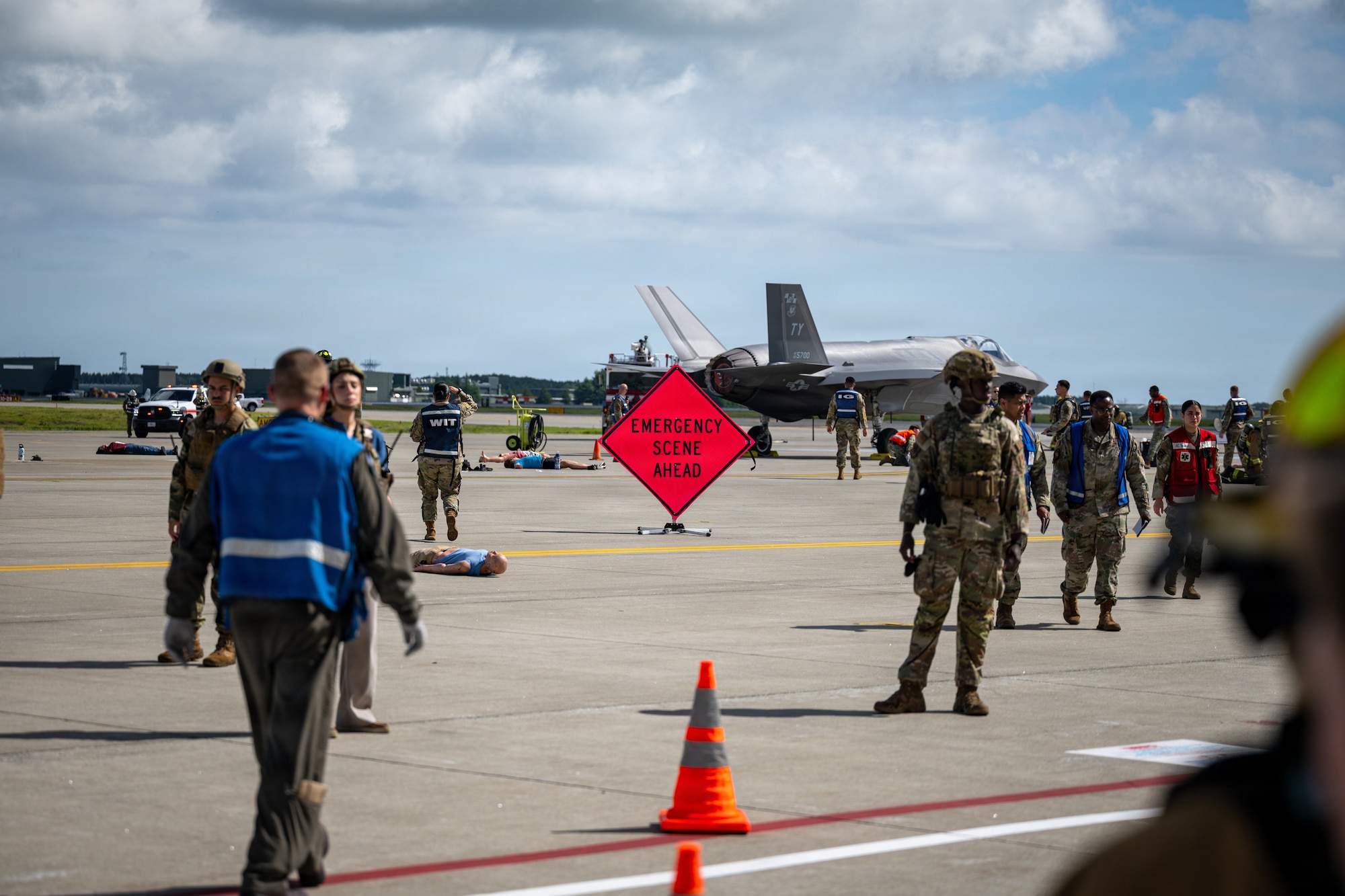 U.S. Airmen assigned to the 35th Fighter Wing, Navy hospital corpsmen assigned to Naval Air Facility Misawa, and Japan Air Self-Defense Force airmen assigned to the 3rd Air Wing respond to a simulated U.S. Air Force F-35A Lightning II crash during an aircraft mass casualty exercise.