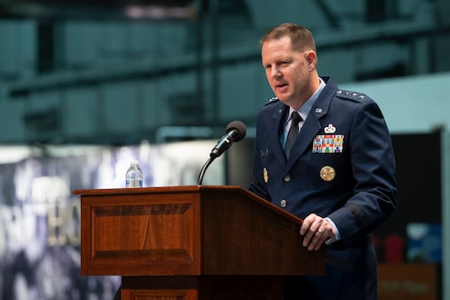 Man in Air Force dress blues at podium.
