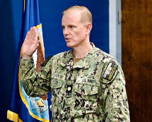 Great Lakes, Ill. - Lt. Cmdr. Robert Johnson, Medical Officer Programs and Scholarships officer assigned to Navy Talent Acquisition Group Great Lakes, administers the commissioning oath to Ensign Itzel Gonzalez during one of two commissioning ceremonies held that day.