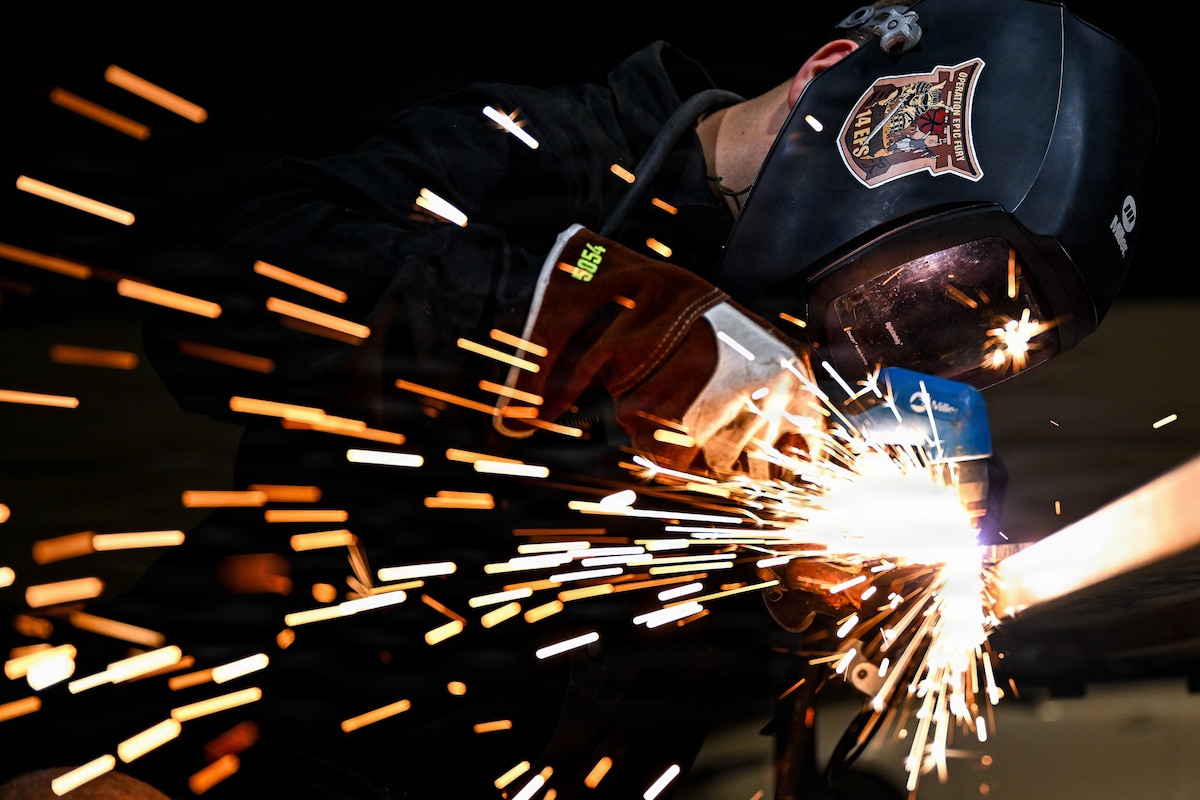 A U.S. Air Force aircraft metals technology specialist uses a plasma cutter to shape raw materials at an undisclosed location within the U.S. Central Command area of responsibility, Aug. 14, 2026. Metals technology specialists use precision welding and machining to manufacture critical components, keeping regional combat aircraft mission ready. (U.S. Air Force photo by Staff Sgt. Justin W. Moore)