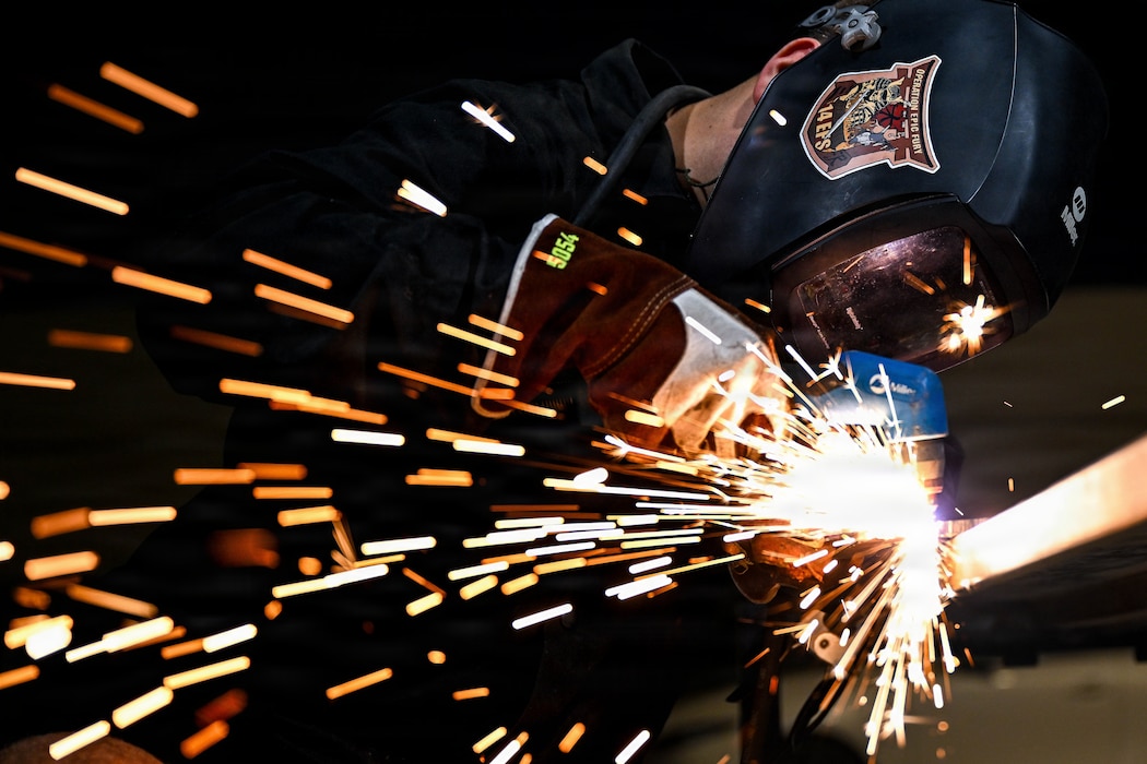 A U.S. Air Force aircraft metals technology specialist uses a plasma cutter to shape raw materials at an undisclosed location within the U.S. Central Command area of responsibility, Aug. 14, 2026. Metals technology specialists use precision welding and machining to manufacture critical components, keeping regional combat aircraft mission ready. (U.S. Air Force photo by Staff Sgt. Justin W. Moore)