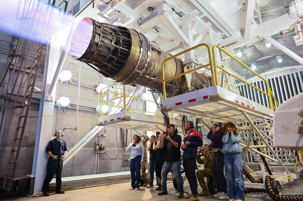 U.S. Air Force Airman 1st Class Sullivan Cox, a 48th Component Maintenance Squadron aerospace propulsion journeyman, demonstrates jet engine testing for military families during a spouse immersion tour at RAF Lakenheath, United Kingdom, Aug. 19, 2026. The tour provided families with a behind-the-scenes look at the squadron’s role in sustaining the 48th Fighter Wing’s mission readiness. (U.S. Air Force photo by Airman Evan Manalastas)