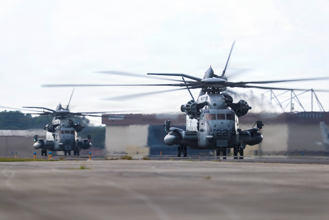 Two U.S. Marine Corps CH-53E Super Stallions with Marine Heavy Helicopter Squadron (HMH) 464, Marine Aircraft Group 29, 2nd Marine Aircraft Wing, taxi during expeditionary advanced base operations at Naval Air Station Jacksonville, Florida, Aug. 4, 2026. The training focused on establishing rapid rearming capabilities in uncontrolled environments, enabling Marines to quickly load ordnance onto F-35B Lightning II aircraft within an uncontrolled area to maintain a lethal and agile forward-deployed presence. (U.S. Marine Corps photo by Lance Cpl. Julius Hackney)