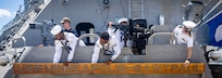 260827-N-VW723-0040 NAVAL STATION MAYPORT, Fla. (Aug. 27, 2026) - Sailors aboard Freedom-class littoral combat ship USS Minneapolis-Saint Paul (LCS 21) attach their namesake before departing Naval Station Mayport to begin operations in support of its scheduled deployment, Aug. 27, 2026. Littoral combat ships are fast, agile, mission-focused platforms designed to operate in near-shore environments and defeat 21st-century coastal threats, supporting the U.S. Navy's goals of forward presence, maritime security, sea control, and deterrence. (U.S. Navy photo by Mass Communication Specialist 1st Class Keenan Daniels)