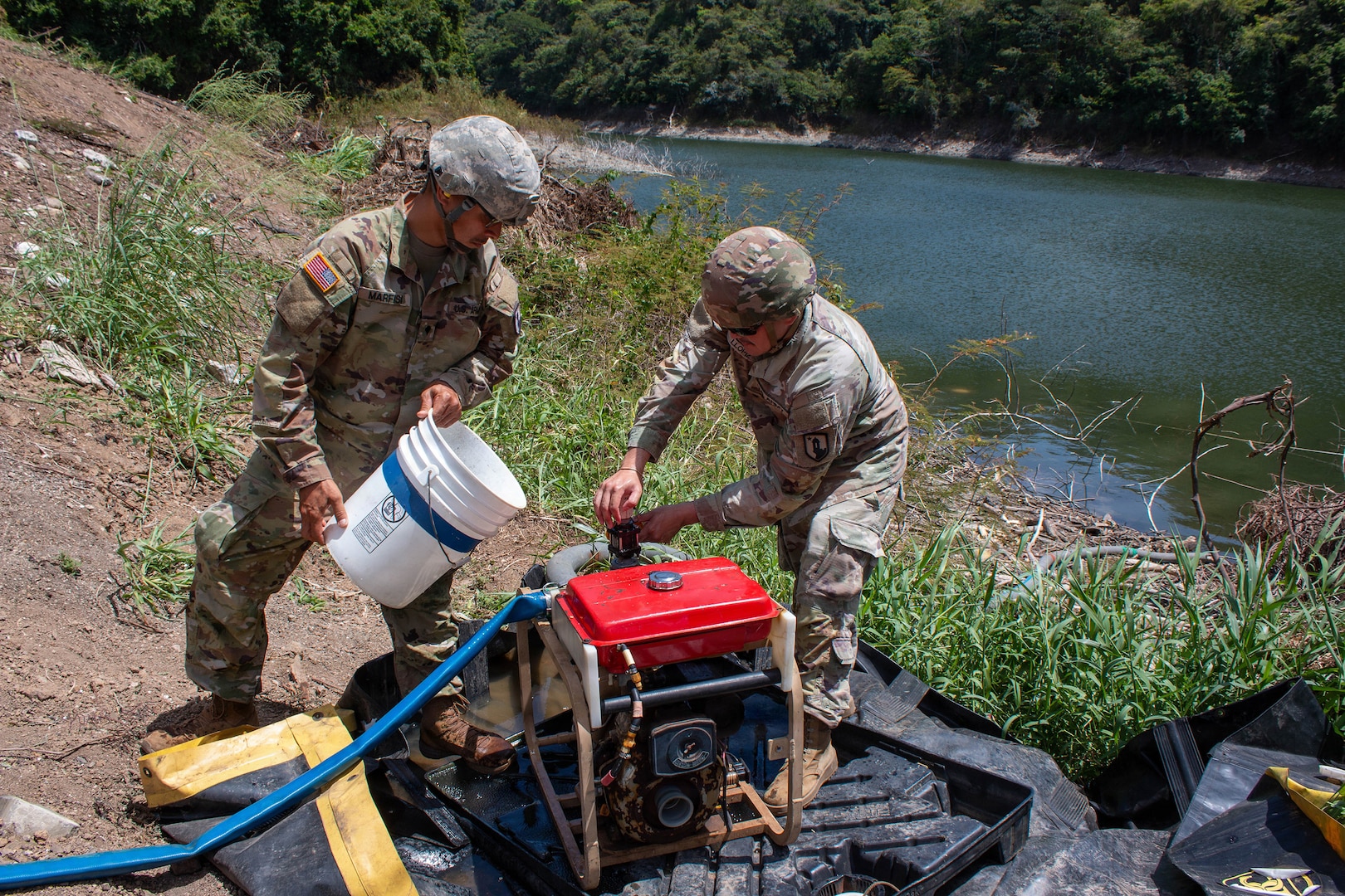 Spc. Jose Marfisi and Spc. Esteven Llopiz, assigned to the 714th Quartermaster Water Purification Company, secure a raw water intake pump during a Water Purification Rodeo at Lago Cerrillos, Ponce, Puerto Rico, July 24, 2026.