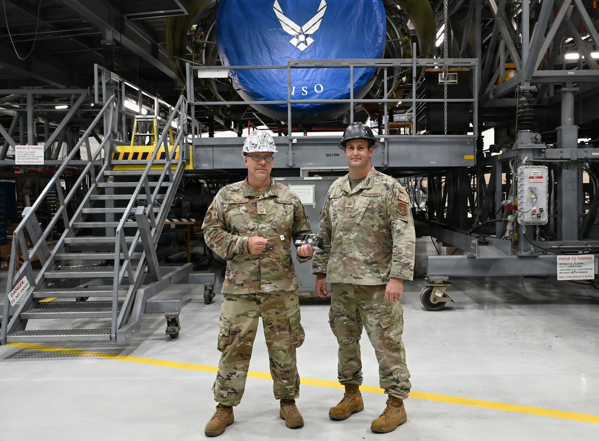 Senior Master Sgt. Chad Bryant (left) and Master Sgt. Tyler Dickson, 512th Maintenance Squadron maintainers, display their creation, a gauge for a variable stator vane lever linkages rigging set for a C-5M Super Galaxy aircraft, at Dover Air Force Base, Delaware, Aug. 1, 2026. The rigging set can reduce the time spent on adjusting the system from 200 to 16 man-hours. (U.S. Air Force photo by Jeremy Larlee)