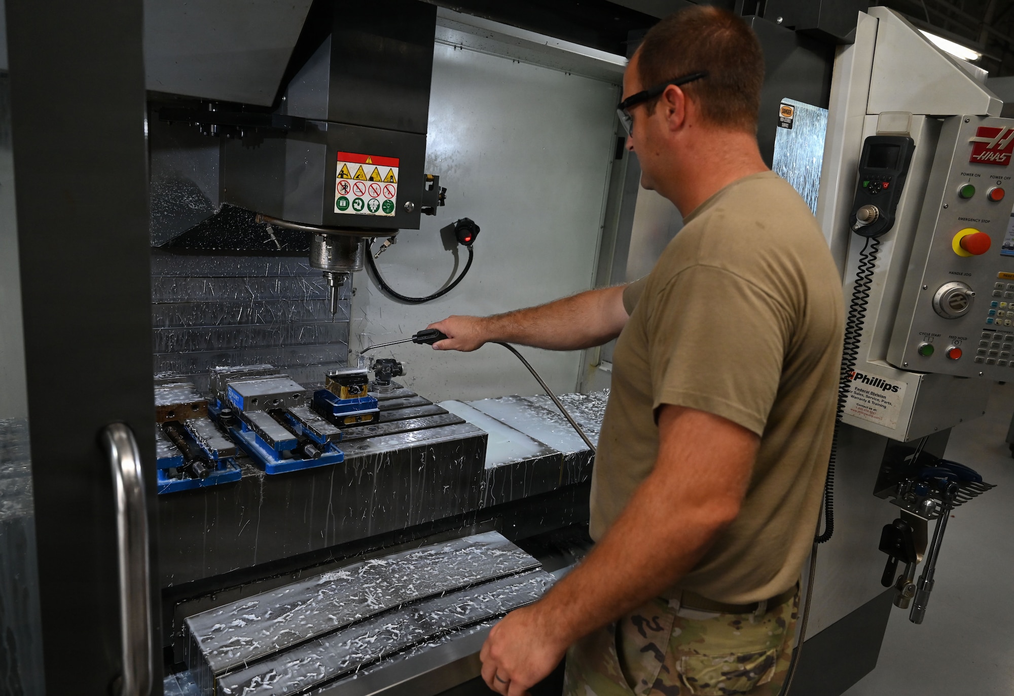 Master Sgt. Tyler Dickson, 512th Maintenance Squadron aircraft metals technology section chief, uses a Haas VF-3SS vertical machining center to build a variable stator vane lever linkages rigging set gauge for a C-5M Super Galaxy aircraft, at Dover Air Force Base, Delaware, Aug. 1, 2026. The rigging set could be key to avoiding expensive and dangerous compressor stalls on the aircraft’s F-138-GE100 engines. (U.S. Air Force photo by Jeremy Larlee)