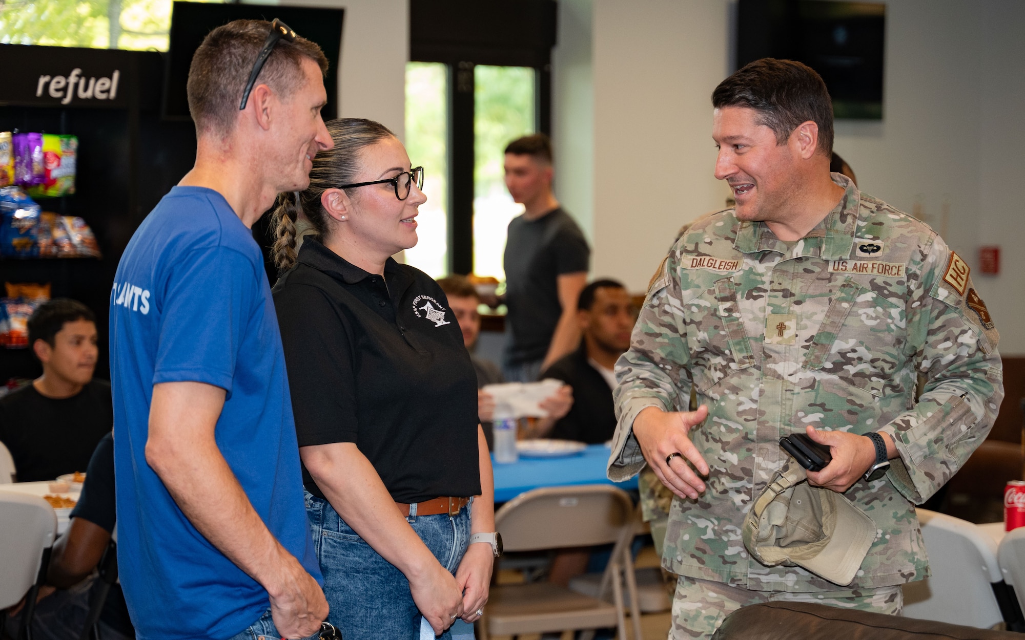 From left, U.S. Air Force Master Sgt. Nicholas Biersner, the first sergeant assigned to the 89th Airlift Wing, Master Sgt. Samantha Pearson, the first sergeant assigned to the 316th Wing, and Lt. Col. Lucas Dalgleish, a chaplain assigned to the 316th Wing, talk during dorm dinner