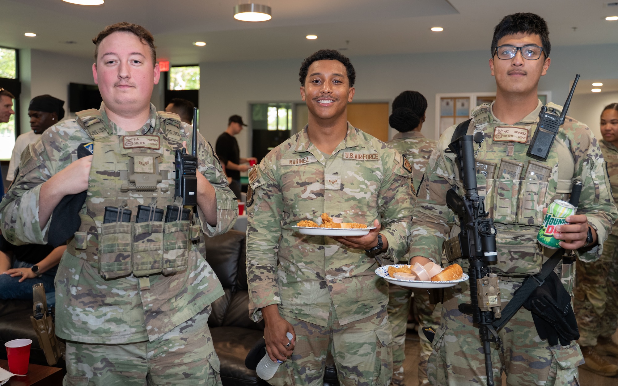 From left, U.S. Air Force Senior Airman Chase, Patten, Airman 1st Class Luis Marinez and Airman 1st Class Ramon Alvarez, all Security Forces Defenders assigned to the 316th Security Forces Squadron, attend a dorm dinner