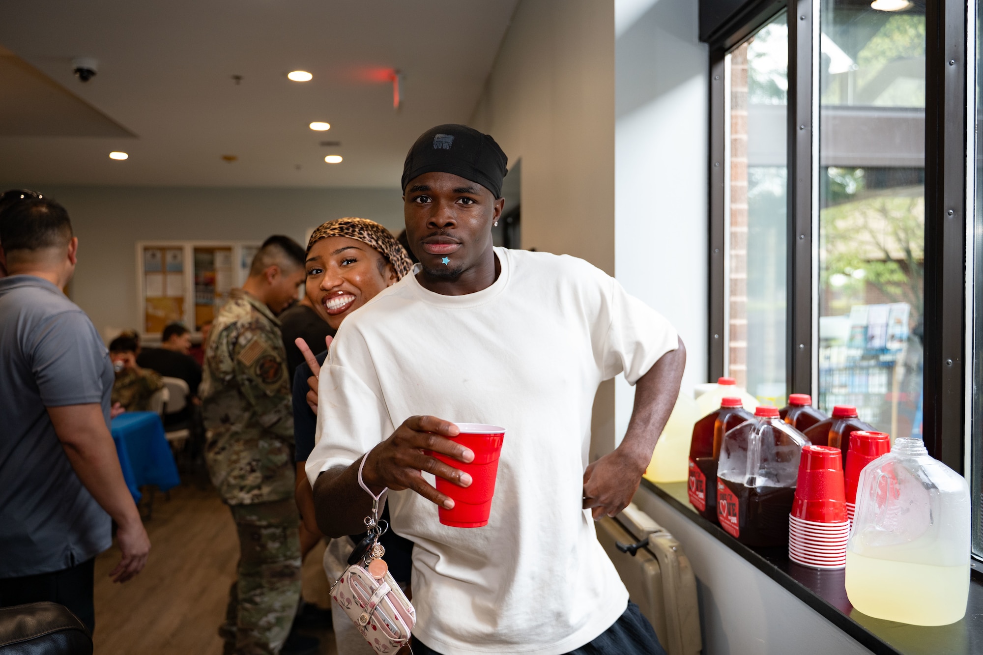 U.S. Air Force Airman 1st Class Christina, Diaz, a Health Services Management Apprentice assigned to the Medical Administration, and Airman Marcus Williams, a Fire Protection Specialist from the 316th Civil Engineer Squadron attend a dorm dinner