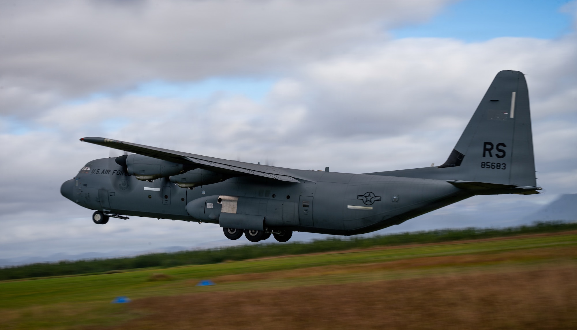 A U.S. Air Force C-130J Super Hercules aircraft assigned to the 37th Airlift Squadron takes off from a grass landing zone prepared by the 435th Contingency Response Group during Northern Viking 26 in Iceland