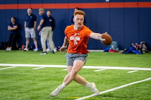 U.S. Space Force Tech. Sgt. Parker Martin, 62nd Cyber Squadron tactical developer, catches a football during the USAA Salute to Service Boot Camp