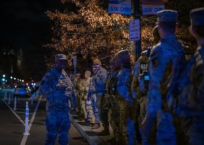 U.S. Army Maj. Edward Lartey, chaplain for the D.C. National Guard, offers words of encouragement to service members gathered at the Eisenhower Memorial ahead of the honor escort—also known as a fallen soldier procession—for U.S. Army Spc. Sarah Beckstrom of the West Virginia National Guard, Nov. 27, 2025. The tradition honors fallen soldiers with silent, unified respect as they are escorted to their final resting place