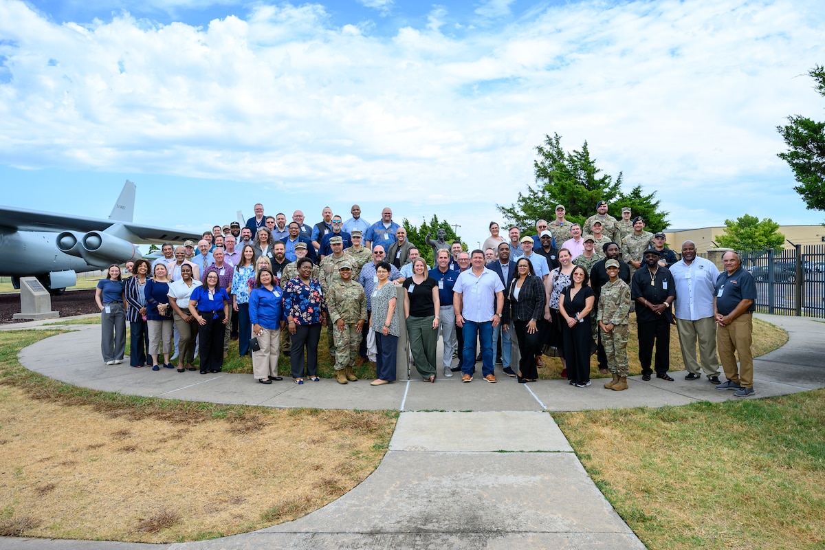 Uniformed and non-uniformed personnel gather at tables